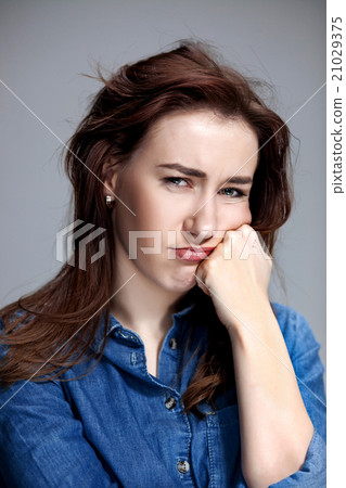 The portrait of a beautiful sad girl closeup The portrait of a beautiful sad girl closeup 21029375