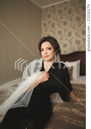 Luxury bride in black robe posing while preparing 21030274