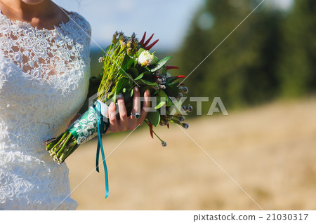 Bouquet in hands of bride. Wedding mountains. Bouquet in hands of bride. Wedding mountains. 21030317