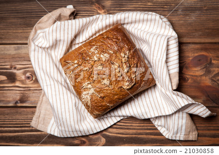 Bread assortment on wooden surface 21030858