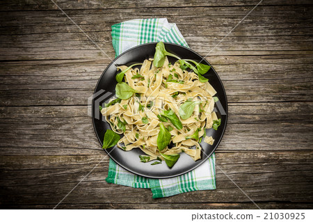 Cooked tagliatelle on a plate Cooked tagliatelle on a plate 21030925