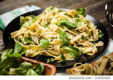 Cooked tagliatelle on a plate Cooked tagliatelle on a plate 21030926