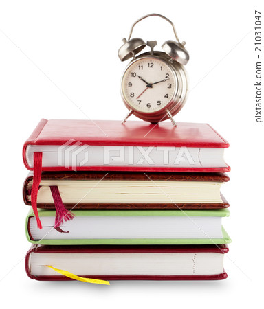 Stack of notebooks with bookmarks and alarm clock Stack of notebooks with bookmarks and alarm clock 21031047