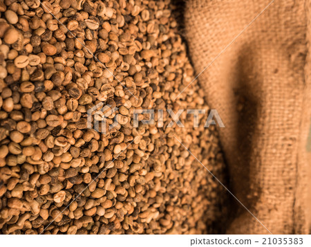 green unroasted coffee beans in sack. 21035383