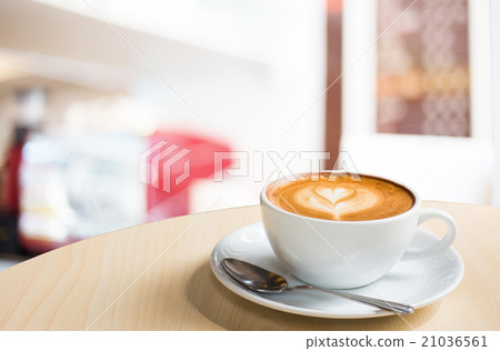 Hot art Latte Coffee in a cup on wooden table Hot art Latte Coffee in a cup on wooden table 21036561