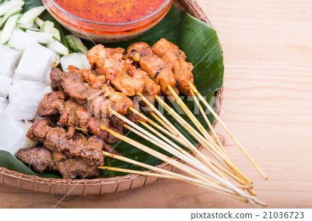 Barbecue satay served on traditional rattan plate Barbecue satay served on traditional rattan plate 21036723