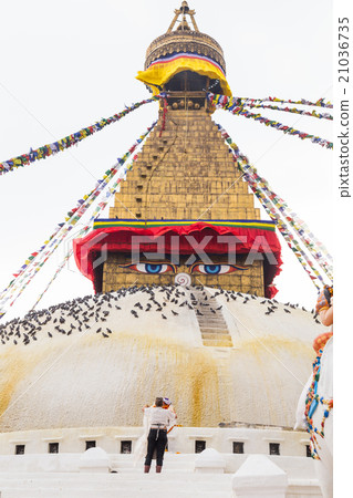 Devotee worshiping the sacred Boudhanath Stupa 21036735