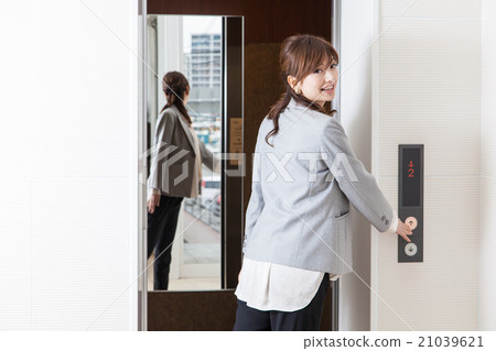 A woman riding an elevator A woman riding an elevator 21039621