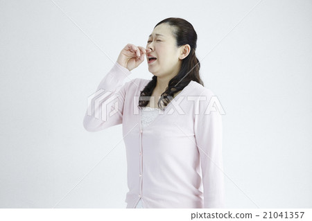 Female in his 40's Female sneezing allergy hay fever natural light white back Female in his 40's Female sneezing allergy hay fever natural light white back 21041357