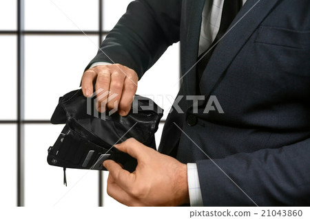 Office employee holding empty wallet. 21043860