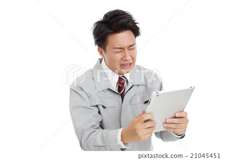 A man in uniform who watches the tablet and cries A man in uniform who watches the tablet and cries 21045451