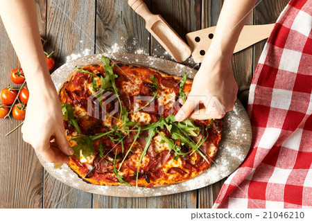 Home made pizza on wooden table Home made pizza on wooden table 21046210