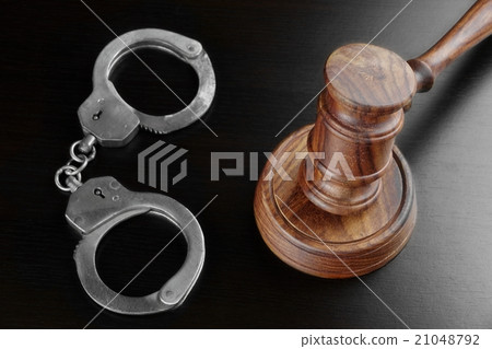 Real Judges Gavel And Handcuffs On The Black Table 21048792