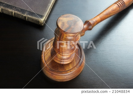 Judges Gavel And Old Book  On The Black Table 21048834