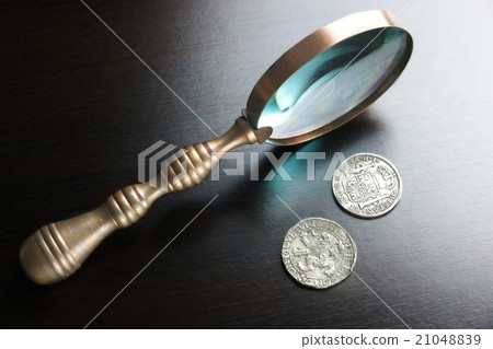 Magnifying Glass And Old Silver Coins On Table Magnifying Glass And Old Silver Coins On Table 21048839
