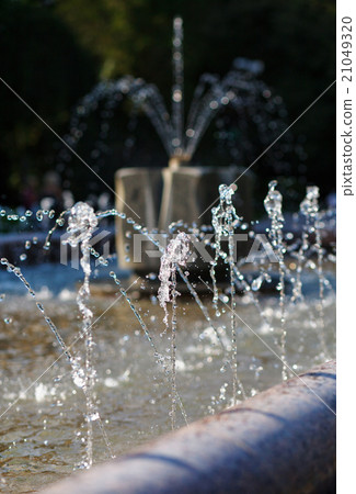 Water stream splashing on ground 21049320