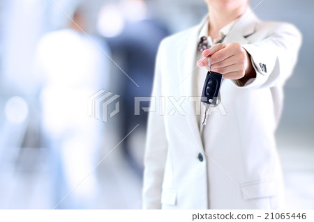 Young successful businesswoman offering a car key. 21065446