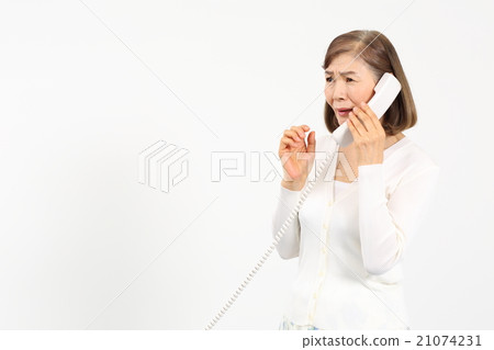 Senior woman surprised while calling Senior woman surprised while calling 21074231