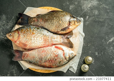 three raw carp fishes 21077411