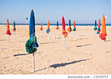 The famous colorful parasols on Deauville beach 21078755