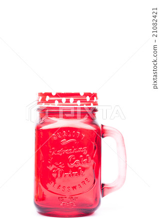 Red mason glass on white background Red mason glass on white background 21082421