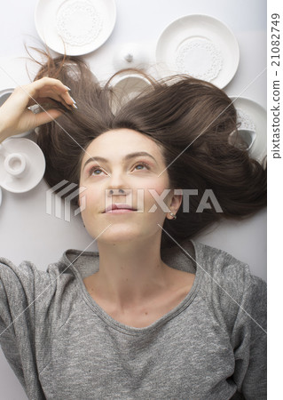 women lies on her back in a white dish 21082749