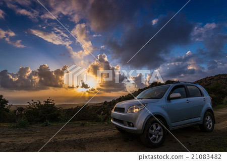car against sunset background 21083482