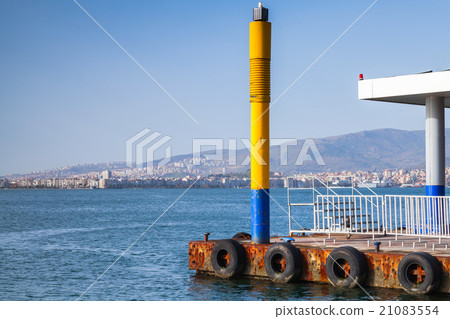 Yellow lighthouse pole on the pier in Izmir city 21083554