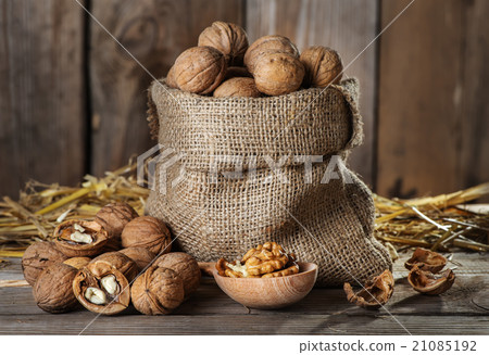 Walnuts on the old wooden background 21085192