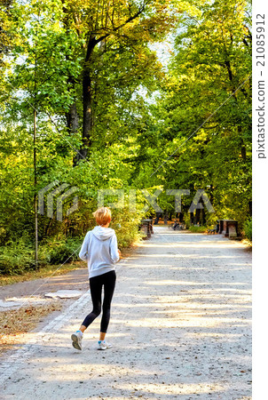 Anorexic woman running in park Anorexic woman running in park 21085912