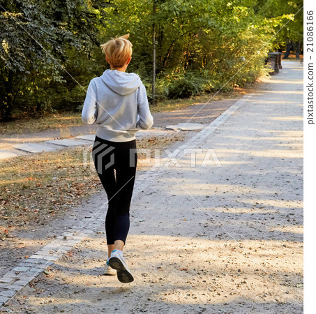 Anorexic woman running in park 21086166