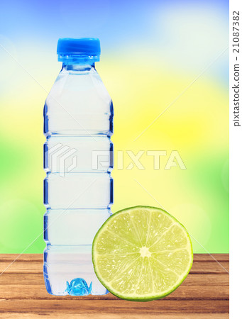 Blue bottle with water and fresh lime on table Blue bottle with water and fresh lime on table 21087382