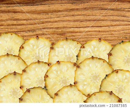 slices of pineapple fruit on wooden background slices of pineapple fruit on wooden background 21087385