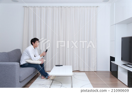 Male everyday lifestyle (30's social person TV living remote control laugh smile relax) 21090609