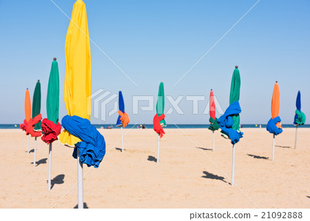 The famous colorful parasols on Deauville beach The famous colorful parasols on Deauville beach 21092888