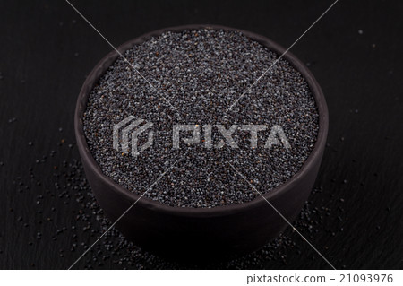 poppy seeds in a stone bowl 21093976