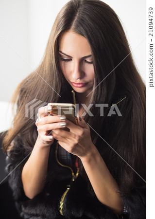 Young woman with a phone Young woman with a phone 21094739