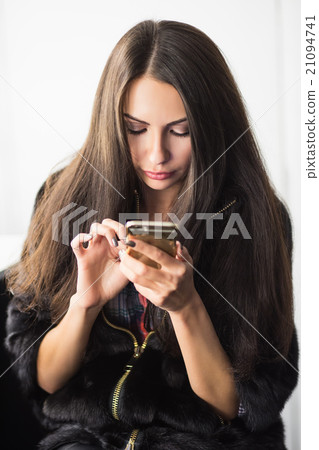 Young brunette with a phone Young brunette with a phone 21094741