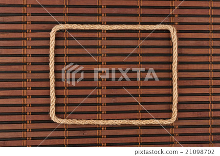Frame of rope, lies on a background of  bamboo mat 21098702