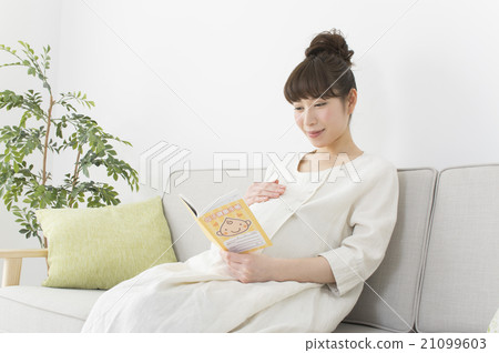Pregnant woman watching maternal and child handbook 21099603