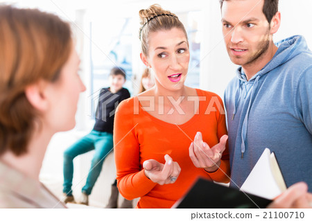 Family and realtor looking at apartment floor plan 21100710