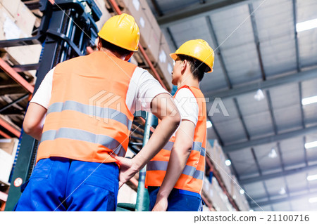 Worker team taking inventory in warehouse Worker team taking inventory in warehouse 21100716