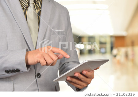 Business Man Browsing Web on tablet at  airport. 21102339
