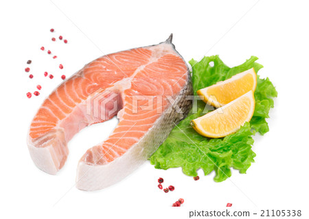 Raw salmon steak with lemon. 21105338