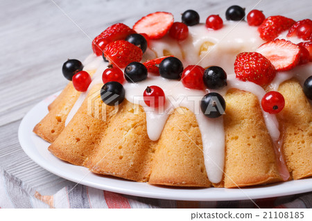 cake with icing and fresh strawberries and currant 21108185