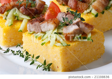 Pieces of polenta with bacon and vegetables macro 21108636