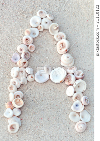 Letters made from seashells on sand 21110122