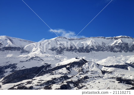Snowy mountains and blue sky at nice sun day 21110271
