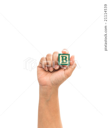 Hand holding colorful alphabet blocks "B" isolated on white 21114539