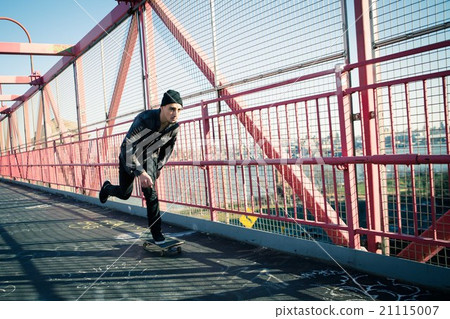 Skateboarder cruise on bridge Skateboarder cruise on bridge 21115007